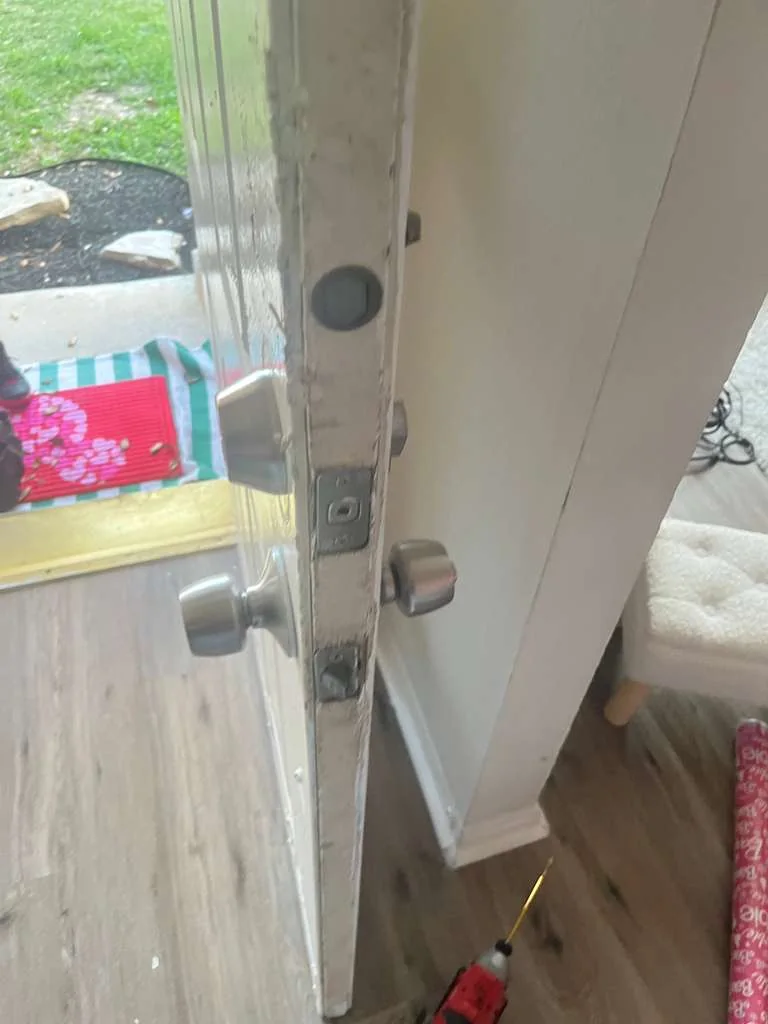 Door strike and frame during a lock alignment check
