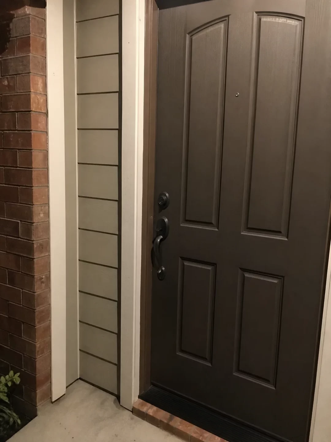 Closed residential front door after dark