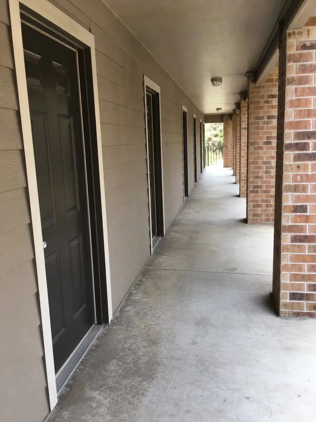 Covered hallway outside Houston apartment doors