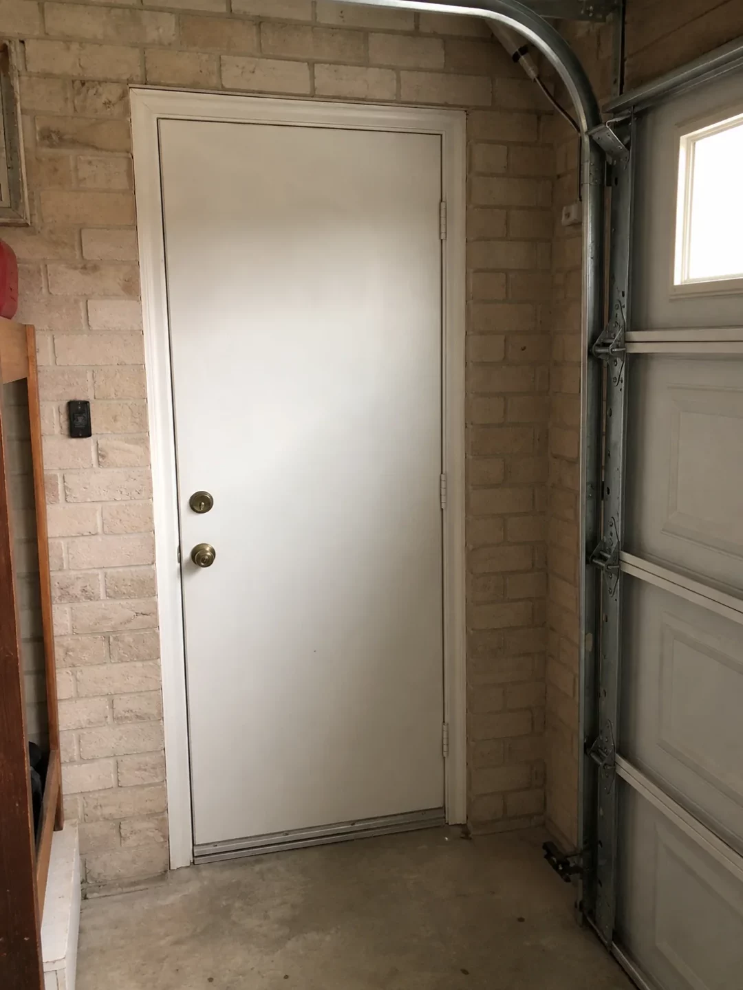 Closed entry door between an attached garage and the home
