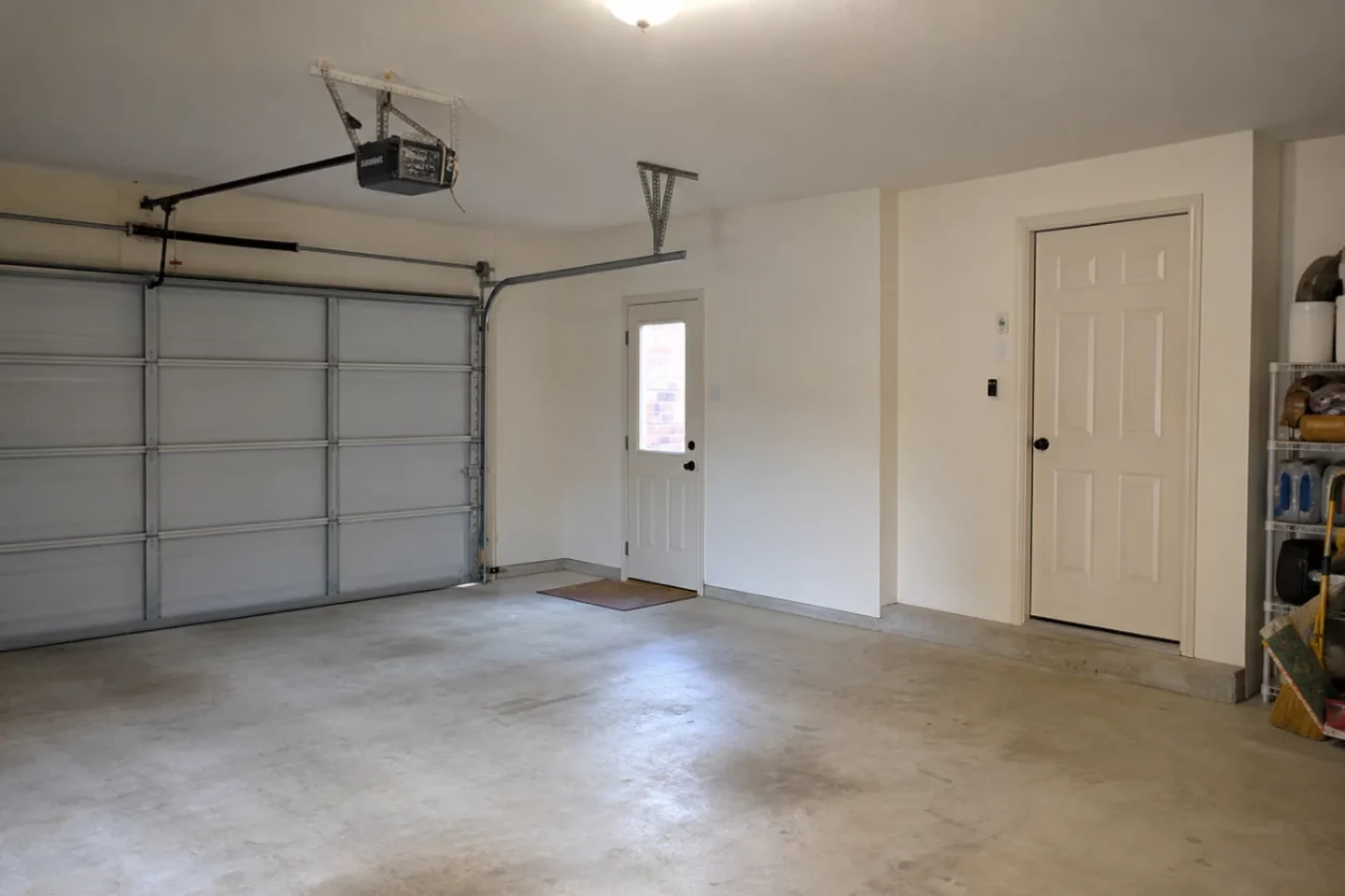Overhead door, side door, and house entry inside an attached garage
