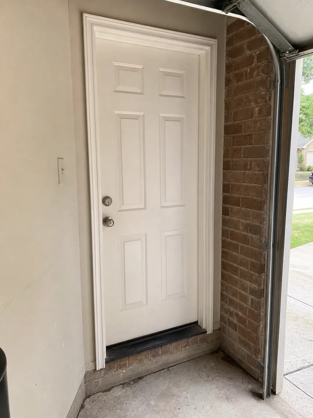 Garage entry door frame, threshold, and lock hardware